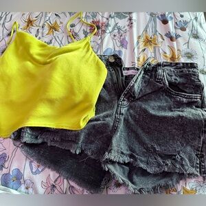 green shirt, black jean shorts